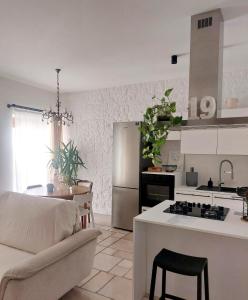 a kitchen and living room with a couch and a table at Casa Vittoria Martina Franca in Martina Franca
