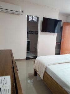 Postel nebo postele na pokoji v ubytování Hotel Cima Real + 2 fotografie