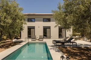 a swimming pool in front of a house at Aniso villa in Svoronata