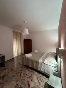 a bedroom with a bed and a couch in it at Ninfa Roda B&B in Vietri sul Mare