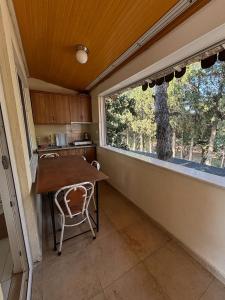 a small kitchen with a table and a window at Cicek Aile Pansiyonu in Burhaniye +35 photos