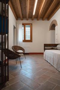 a bedroom with a bed and a table and chairs at Casa Cantia at Villa Mascarello Noventa in Breganze +21 photos