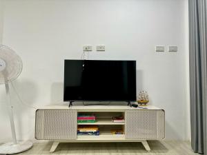 a flat screen tv sitting on a white entertainment center at Yipso Residency in Yala