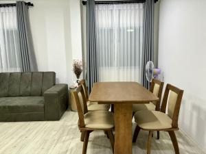 a table and chairs in a living room with a couch at Yipso Residency in Yala