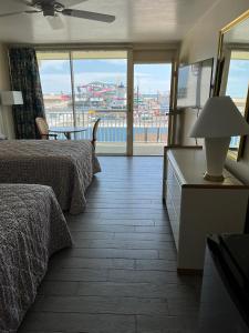 a hotel room with two beds and a large window at Landmark Motel in Wildwood