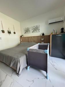 a bedroom with a bed and a large television at Kaz' Kiki Coco in Folle Anse +32 photos