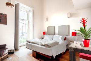 a white bedroom with a bed and a large window at Micalò Art Rooms in Naples +24 photos