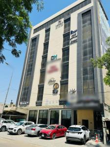 a building with cars parked in front of it at Diamond apartments, شقق الماس الحديثة- حي القادسية اليرموك in Baghdad