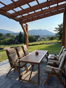 a wooden table and chairs on a patio at Casa Dobra in Dobra