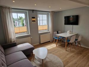 a living room with a couch and a table at Haus am Markt in Sagard
