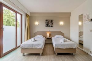 Letto o letti in una camera di Sleep & Go Brussels South