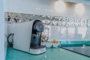 a coffee maker sitting on a counter in a kitchen at Casa Mazagón con vistas al mar in Mazagón