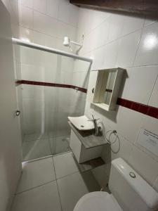 a bathroom with a toilet and a shower and a sink at Break House Beach in Florianópolis +12 photos