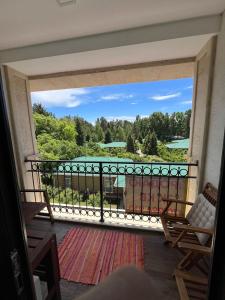 a room with a balcony with a view of the water at Raduga Alfa in Chon-Sary-Oy