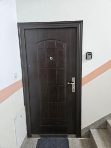 a black door in a building with stairs at Velike Šume Apartment in Pale