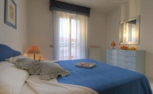 a teddy bear sitting on top of a bed at Residence I Giardini Del Conero in Porto Recanati