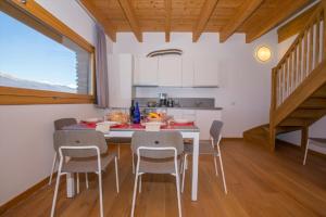 a kitchen with a table and chairs in a room at paradiso del lago t4 in Bellano +44 photos