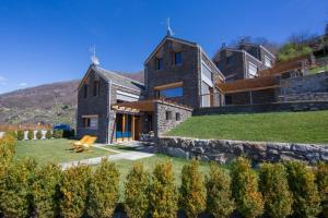 a large house on a hill with a yard at paradiso del lago t4 in Bellano