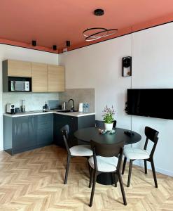 a kitchen and dining room with a table and chairs at Apartament TAMAJA in Bielsko-Biala