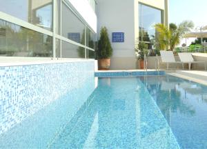 a swimming pool in a house with a blue at Angela Studios Apartments in Sissi
