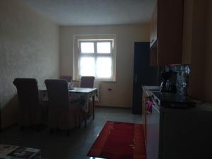 a kitchen with a table and chairs and a window at Ferienwohnung Sonnenblick in Adorf