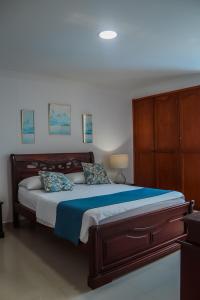 a bedroom with a large bed with a wooden headboard at apto una alcoba in Cartagena de Indias +18 photos