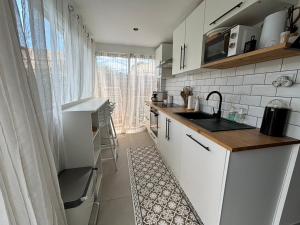 a kitchen with a sink and a counter top at La maison du bonheur in Mèze
