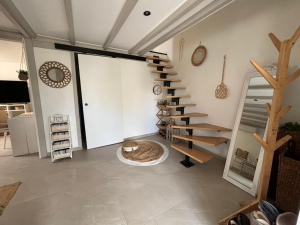 a living room with a spiral staircase in a house at La maison du bonheur in Mèze +6 photos