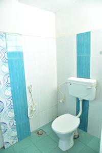 a bathroom with a toilet and a shower at Sithara Guest House in Palakkad