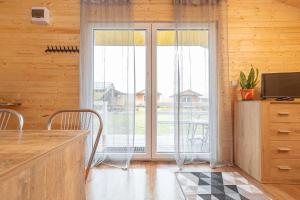 a kitchen with a large sliding glass door at Chatki u Atki in Darłowo