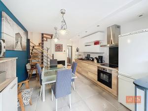 a kitchen with a table and a dining room at Le Petit Loft in Wimille