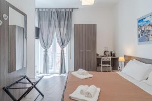 Postel nebo postele na pokoji v ubytování Cavour Rooms