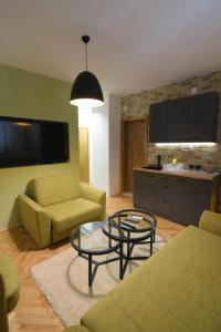 a living room with a couch and a table at Station 44 Apartments in Bitola