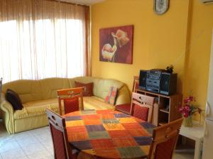 a living room with a table and a couch at Babati Apartmanház in Zalakaros