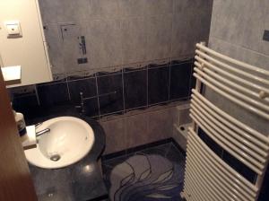 a bathroom with a sink and a toilet at Babati Apartmanház in Zalakaros +8 photos