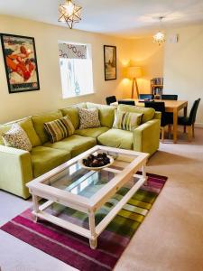 a living room with a couch and a coffee table at The Coach House in Par