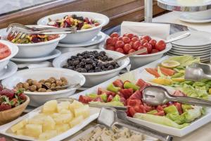 a buffet filled with different types of fruits and vegetables at Perapolis Hotel in Istanbul