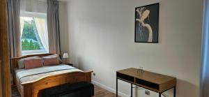 a small bedroom with a bed and a window at Lipowy Kąt in Gołdap