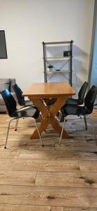 a wooden table with four chairs in a room at Lipowy Kąt in Gołdap +8 photos