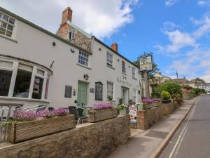 a white building on the side of a street at Tri-Star House in Charmouth