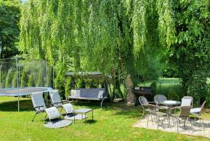 a group of chairs and a table in a yard at Dom - Nielisz - do wynajęcia in Nielisz