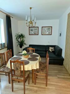 a living room with a table and chairs and a couch at Dom - Nielisz - do wynajęcia in Nielisz