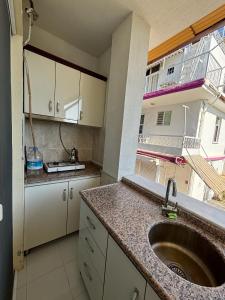 a kitchen with a sink and a counter top at Cicek Aile Pansiyonu in Burhaniye