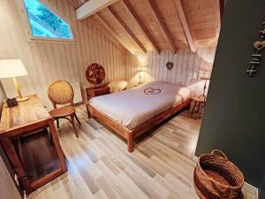 a bedroom with a bed and a table and chairs at le chalet du bout du lac in Gérardmer +28 photos