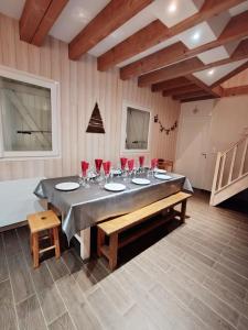 a dining room with a table with wine glasses on it at le chalet du bout du lac in Gérardmer