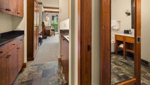 a kitchen with a hallway leading to a living room at 309 VILLAGE GREEN By Stowe Mountain Rentals in Stowe