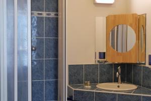 a bathroom with a sink and a mirror at Les chambres de l'Elysée in Pontrieux +5 photos