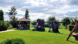 a playground with a swing set and a gazebo at Gościniec Krys in Żnin