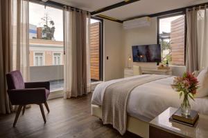 a bedroom with a large bed and a large window at Hacienda Peña Pobre in Mexico City