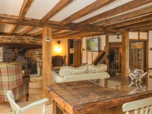 a living room with a couch and a table at Fishermen's Cottage in Chulmleigh